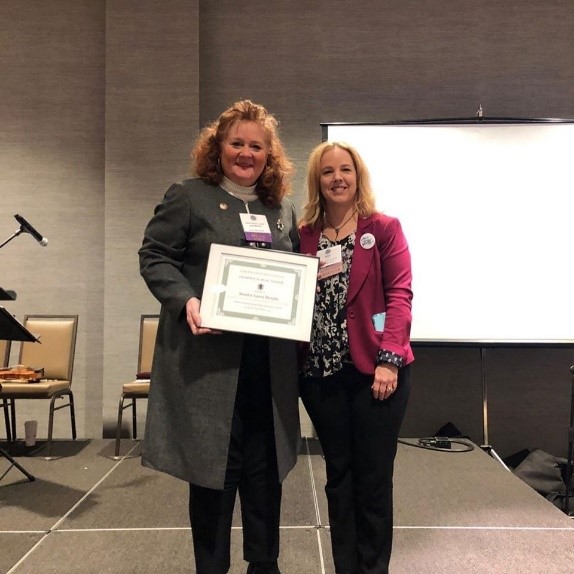 Leader Laura Murphy receiving the Champion of Music Therapy Award from IL Government Relations Chair Nancy Swanson